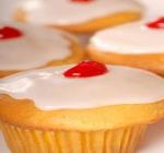 cupcake with lemon frosting and cherry