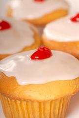 cupcake with lemon frosting and cherry