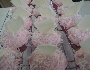 cupcakes with pink buttercream frosting and and coconut and white chocolate